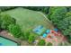 Aerial view of grassy field with playground, soccer field, and basketball court at 5245 Cottage Farm Rd, Johns Creek, GA 30022