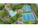 Aerial view showing pool, playground and tennis courts in a wooded setting at 5245 Cottage Farm Rd, Johns Creek, GA 30022