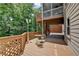 Multi-level wood back deck with a table and chairs offers great views of the backyard at 5245 Cottage Farm Rd, Johns Creek, GA 30022