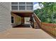 Lower level of wooden deck, great for outdoor gatherings; includes stairs to screened porch and landscaped surroundings at 5245 Cottage Farm Rd, Johns Creek, GA 30022