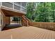 Lower level of wooden deck; stairs to screened porch and lush backyard with wooded views at 5245 Cottage Farm Rd, Johns Creek, GA 30022