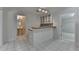 Open bar area featuring tiled floor, built-in cabinets, counterspace, and a black and white checkered backsplash at 5245 Cottage Farm Rd, Johns Creek, GA 30022