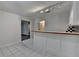 Open bar area featuring tiled floor, built-in cabinets, counterspace, and a black and white checkered backsplash at 5245 Cottage Farm Rd, Johns Creek, GA 30022