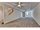Spacious basement with neutral carpet and walls, a ceiling fan, and a staircase at 5245 Cottage Farm Rd, Johns Creek, GA 30022