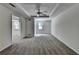 Large finished basement with carpet, neutral walls, ceiling fan, and natural light at 5245 Cottage Farm Rd, Johns Creek, GA 30022