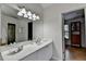 White vanity with brushed nickel faucet in bright bathroom with tile flooring at 5245 Cottage Farm Rd, Johns Creek, GA 30022