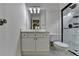 Bright bathroom featuring sleek white cabinets, neutral walls, and a glass shower enclosure at 5245 Cottage Farm Rd, Johns Creek, GA 30022