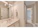 Bright bathroom with a single vanity, white cabinets, neutral walls, and a mirror at 5245 Cottage Farm Rd, Johns Creek, GA 30022