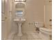 Simple bathroom with white toilet, pedestal sink, mirror, and tiled floor in a neutral color palette at 5245 Cottage Farm Rd, Johns Creek, GA 30022
