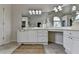 Bright bathroom featuring dual vanities with decorative mirrors and tile floors at 5245 Cottage Farm Rd, Johns Creek, GA 30022