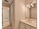 Bathroom with white vanity, mirror, light fixture, and view to bedroom at 5245 Cottage Farm Rd, Johns Creek, GA 30022