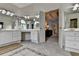 This bathroom boasts dual vanities, tile floors and is open to the hall at 5245 Cottage Farm Rd, Johns Creek, GA 30022