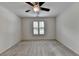 Bright bedroom with a ceiling fan, neutral walls, and a window with shutters at 5245 Cottage Farm Rd, Johns Creek, GA 30022