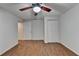 Bedroom featuring wood floors, closet and a modern ceiling fan at 5245 Cottage Farm Rd, Johns Creek, GA 30022