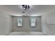 Bright bedroom with carpet floor, two windows, and modern ceiling light fixture at 5245 Cottage Farm Rd, Johns Creek, GA 30022