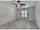 Bright bedroom with a ceiling fan, neutral walls, and a window with shutters at 5245 Cottage Farm Rd, Johns Creek, GA 30022