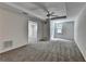 Spacious bedroom with a ceiling fan, gray carpet and a view to another room at 5245 Cottage Farm Rd, Johns Creek, GA 30022