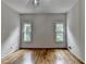 Bedroom with hardwood floors, two windows, and a modern light fixture at 5245 Cottage Farm Rd, Johns Creek, GA 30022