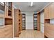 Large walk-in closet with wood flooring and multiple custom shelves and drawers at 5245 Cottage Farm Rd, Johns Creek, GA 30022