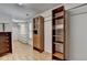 Walk-in closet featuring custom shelves, drawers, wood floors and a window at 5245 Cottage Farm Rd, Johns Creek, GA 30022