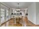 Dining area with a table and chairs, hardwood flooring, and a view of the kitchen at 5245 Cottage Farm Rd, Johns Creek, GA 30022