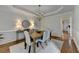 Elegant dining room featuring wainscoting, a chandelier, and stylish furnishings at 5245 Cottage Farm Rd, Johns Creek, GA 30022