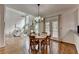 Dining area with a table and chairs, hardwood flooring, and a view of the living room at 5245 Cottage Farm Rd, Johns Creek, GA 30022