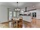 Dining area with a table and chairs, hardwood flooring, and a view of the kitchen at 5245 Cottage Farm Rd, Johns Creek, GA 30022