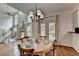 Dining area with a table and chairs, hardwood flooring, and a view of the living room at 5245 Cottage Farm Rd, Johns Creek, GA 30022