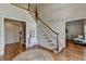 Grand foyer with hardwood floors, a sweeping staircase, and elegant wainscoting at 5245 Cottage Farm Rd, Johns Creek, GA 30022