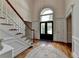 Welcoming foyer features a staircase, hardwood floors, and an arched window above the door at 5245 Cottage Farm Rd, Johns Creek, GA 30022
