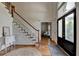 Spacious foyer with hardwood floors, a staircase, and an inviting doorway at 5245 Cottage Farm Rd, Johns Creek, GA 30022