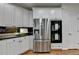 Bright kitchen features stainless steel appliances, white cabinets, and black countertops at 5245 Cottage Farm Rd, Johns Creek, GA 30022