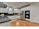 Bright kitchen features white cabinets, dark countertops, stainless appliances, and hardwood floors at 5245 Cottage Farm Rd, Johns Creek, GA 30022