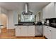 Eat-in kitchen features white cabinets, dark countertops, stainless appliances, and hardwood floors at 5245 Cottage Farm Rd, Johns Creek, GA 30022