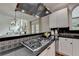 Kitchen detail shows dark countertops and stainless steel gas cooktop at 5245 Cottage Farm Rd, Johns Creek, GA 30022