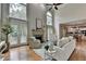 Bright living room featuring large windows, hardwood floors, a fireplace, and neutral decor at 5245 Cottage Farm Rd, Johns Creek, GA 30022
