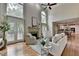 Open-concept living room with tall windows, fireplace, and seamless connection to the kitchen, perfect for entertaining at 5245 Cottage Farm Rd, Johns Creek, GA 30022