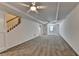 Spacious living room with carpet floor, fan, recessed lights, and staircase at 5245 Cottage Farm Rd, Johns Creek, GA 30022