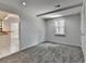 Versatile room with neutral walls, gray carpet, window, and access to the kitchen at 5245 Cottage Farm Rd, Johns Creek, GA 30022