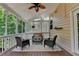 Comfortable screened porch features a ceiling fan and outdoor furniture for relaxing at 5245 Cottage Farm Rd, Johns Creek, GA 30022