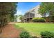 Lush backyard featuring mature trees, green lawn, and wooded perimeter for added privacy at 4653 Glory Maple Trce, Powder Springs, GA 30127