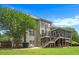 Spacious backyard featuring a well-maintained lawn, patio and deck areas, and mature trees at 4653 Glory Maple Trce, Powder Springs, GA 30127