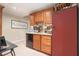 Stylish bar area featuring wood cabinets, granite countertops, a wine cooler, and ample storage space at 4653 Glory Maple Trce, Powder Springs, GA 30127