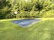 Outdoor basketball court surrounded by green grass offers an ideal space for recreation and exercise at 4653 Glory Maple Trce, Powder Springs, GA 30127