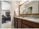 Bathroom vanity featuring granite countertops, double sinks, and dark wood cabinetry at 4653 Glory Maple Trce, Powder Springs, GA 30127