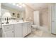 Bright bathroom featuring a single sink vanity and a shower with white curtain at 4653 Glory Maple Trce, Powder Springs, GA 30127