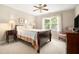 Bright bedroom with a large window, ceiling fan, and a comfortable queen-sized bed at 4653 Glory Maple Trce, Powder Springs, GA 30127