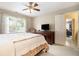 Bedroom features queen bed, large window, ceiling fan, and doorway to an office at 4653 Glory Maple Trce, Powder Springs, GA 30127