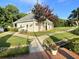 Charming clubhouse with manicured lawn, colorful landscaping, and convenient pathway for easy access at 4653 Glory Maple Trce, Powder Springs, GA 30127